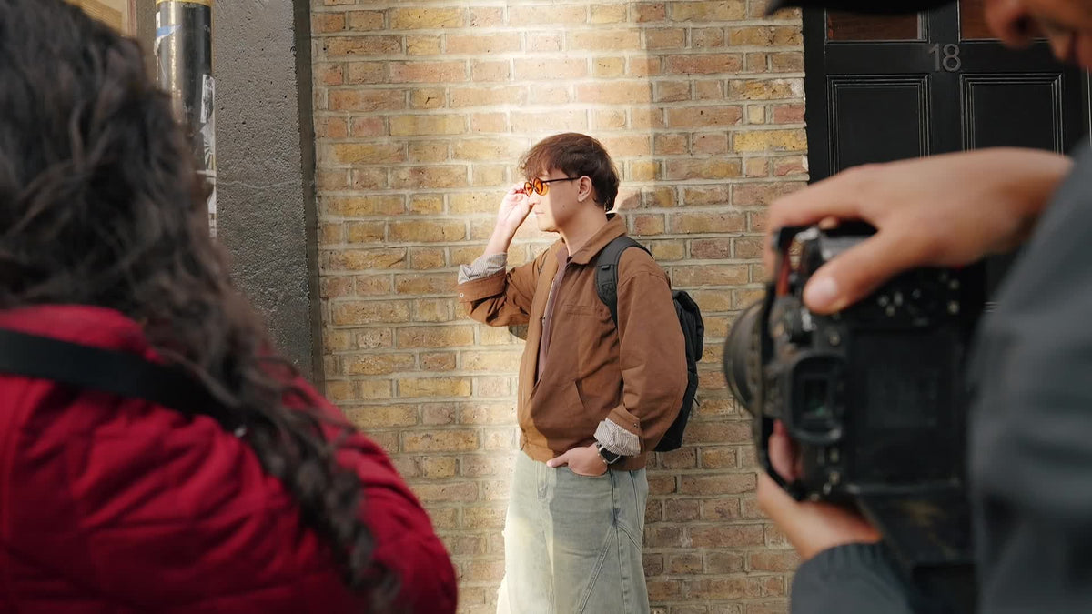Street-style photoshoot in warm sunlight against London brickwork