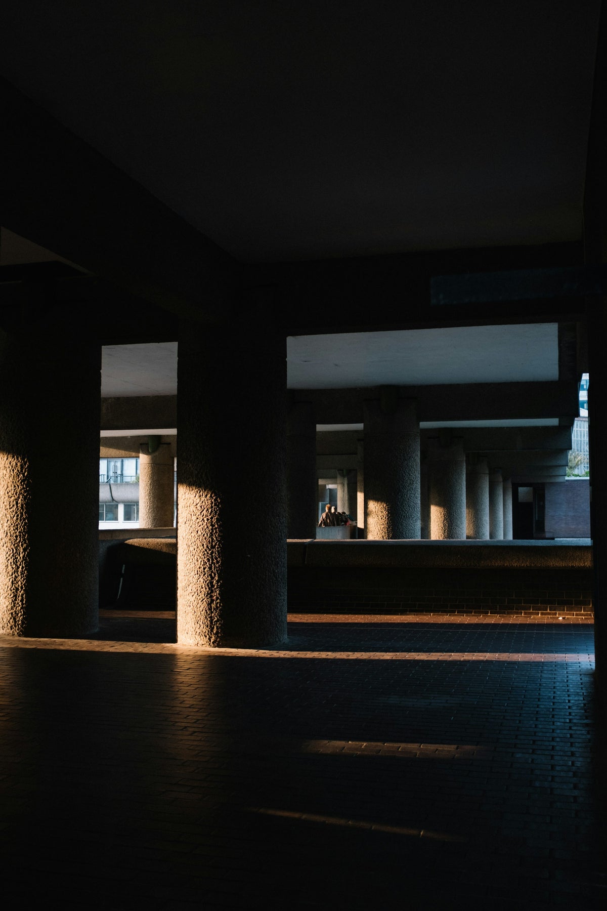 Warm evening sunlight falling between concrete columns in London